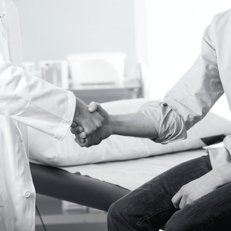 closeup of doctor shaking hands with his patient