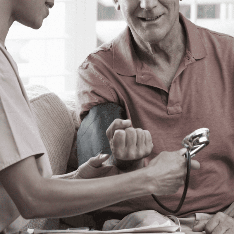 Nurse preparing the take the blood pressure of a patient